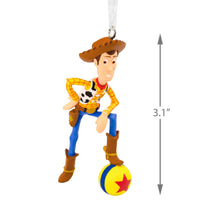 Load image into Gallery viewer, Toy Story Woody Christmas ornament with a ball and star design, on a white background.