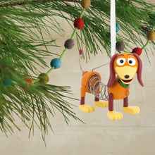 Load image into Gallery viewer, Toy Story Slinky Dog ornament with springs hanging from a Christmas tree.