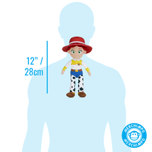 Load image into Gallery viewer, A small Jessie-style plush doll centered on a light blue human silhouette with a vertical measurement marker reading 12" / 28cm. A circular Merchimpo logo appears in the lower right corner.