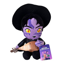 Load image into Gallery viewer, A K-POP Demon Hunters plush toy featuring the character Jinu with purple skin, black hair, and a black hat, holding a brown stringed instrument. A purple product tag with Netflix and K-POP branding is attached to the plush, set against a plain white background.