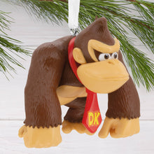 Load image into Gallery viewer, Donkey Kong Christmas ornament with red bandana and DK logo hanging on a tree.