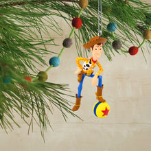 Load image into Gallery viewer, Toy Story Christmas ornament of Woody hanging on a tree branch.