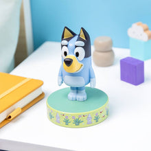 Load image into Gallery viewer, Bluey cartoon dog figurine on a round base with colorful background