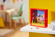 Load image into Gallery viewer, Super Mario Money Box sitting on white shelf in front of yellow wall with coins
