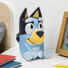 Load image into Gallery viewer, Bluey  cartoon dog-shaped night light on a white surface with books and a photo frame in the background.
