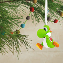 Load image into Gallery viewer, Colorful Yoshi ornament hanging on a Christmas tree branch.
