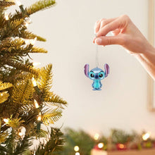 Load image into Gallery viewer, Person decorating a Christmas tree with lights and ornaments in a festive living room.
