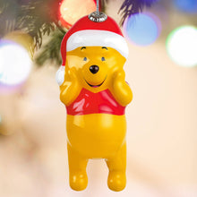 Load image into Gallery viewer, Decorative ornament of a yellow bear in a Santa hat against a blurred Christmas tree background.
