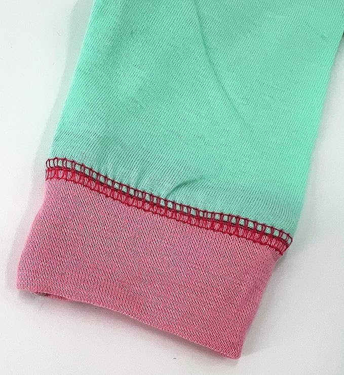 Close-up of a garment with green top and pink bottom on a white background