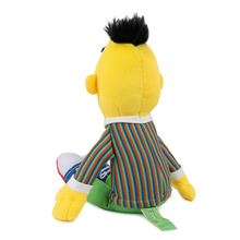 Load image into Gallery viewer, Sesame Street Bert  Plush toy with yellow face, black hair, and colorful striped pants on a white background rear view
