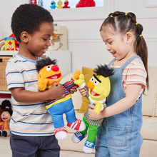 Load image into Gallery viewer, Two children playing with Sesame Street plush toys in a room.
