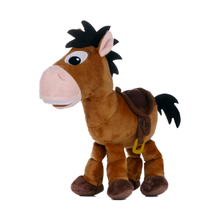 Load image into Gallery viewer, Bullseye plush toy horse fromn Toy Story 5 with brown fur, a pink snout and inner ears, black mane and tail, and a dark saddle with a small yellow buckle, shown on a plain white background.
