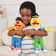 Load image into Gallery viewer, Child holding two Sesame Street plush toys against a neutral background
