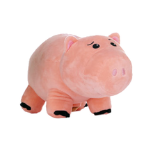 Load image into Gallery viewer, Hamm plush toy from Toy Story 5 shaped like a pink pig, with embroidered black eyes and snout details and black hooves, shown on a plain white background.
