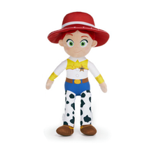 Load image into Gallery viewer, A Jessie the cowgirl plush toy from Toy Story 5, standing against a solid white background. The plush features her signature red hat, yellow shirt, blue pants, and black-and-white cow-print legs.
