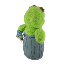 Load image into Gallery viewer, Sesame Street Oscar Green plush toy resembling a tree stump with a tag on a white background rear view

