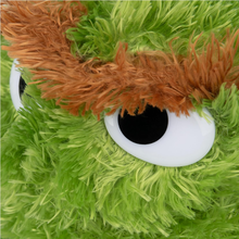 Load image into Gallery viewer, Sesame Street Oscar  Close-up of a green plush toy with a large white eye and brown hair.
