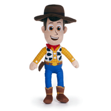 Load image into Gallery viewer, A Woody the Cowboy plush toy from Toy Story 5, featuring his signature yellow plaid shirt, red bandana, blue pants, brown hat and boots, and cow-print vest, set against a plain white background.
