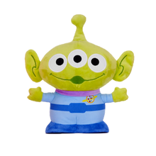 Load image into Gallery viewer, Alien plush toy from Toy Story 5 the green three-eyed Alien, wearing a light blue shirt with a purple collar and blue pants, set against a plain white background.
