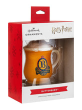 Load image into Gallery viewer, Butterbeer mug ornament in packaging with Hallmark and Harry Potter branding.

