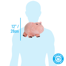 Load image into Gallery viewer, A pink plush pig toy shown on a light blue human silhouette with a vertical measurement marker reading 12" / 28cm, plus a circular 'Merchimpo' logo in the lower right corner.
