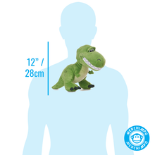 Load image into Gallery viewer, A green plush dinosaur toy shown in front of a light blue human silhouette on a white background, with a vertical measurement marker reading 12" / 28cm and a circular Merchimpo logo in the lower right.
