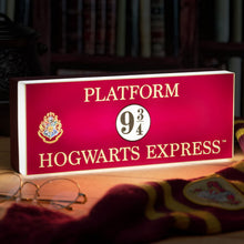 Load image into Gallery viewer, Hogwarts Express Platform Light illuminated lamp sitting on table with Harry Potter glasses and scarf
