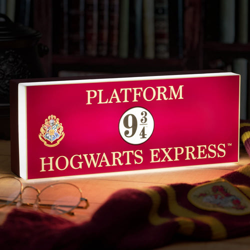 Hogwarts Express Platform Light illuminated lamp sitting on table with Harry Potter glasses and scarf