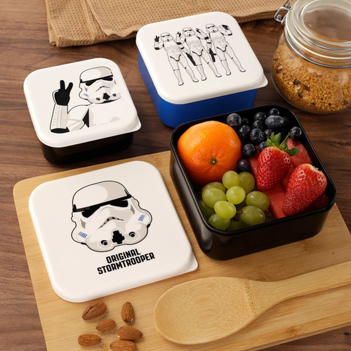 The Original Stormtrooper Stacking Lunch Boxes  on chopping board with fruit