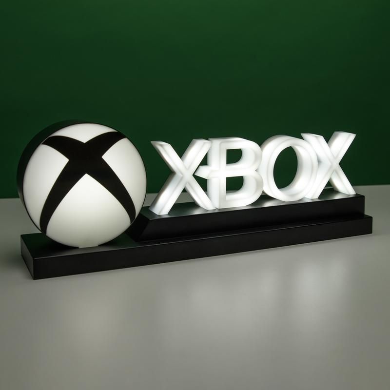 Xbox Logo Light white sitting on white surface with green wall 