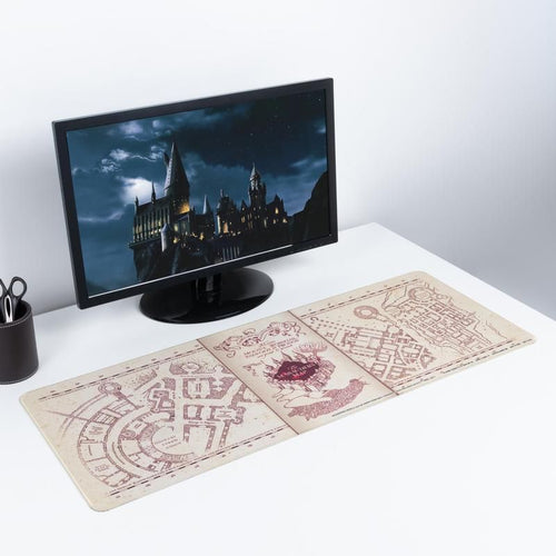 Harry Potter Marauders Map Gaming Desk Mat on desk with monitor showing hogwarts behind