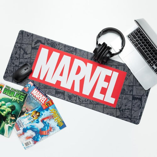 Marvel Logo Gaming Desk Mat on white desk with laptop and headphones and Marvel comics